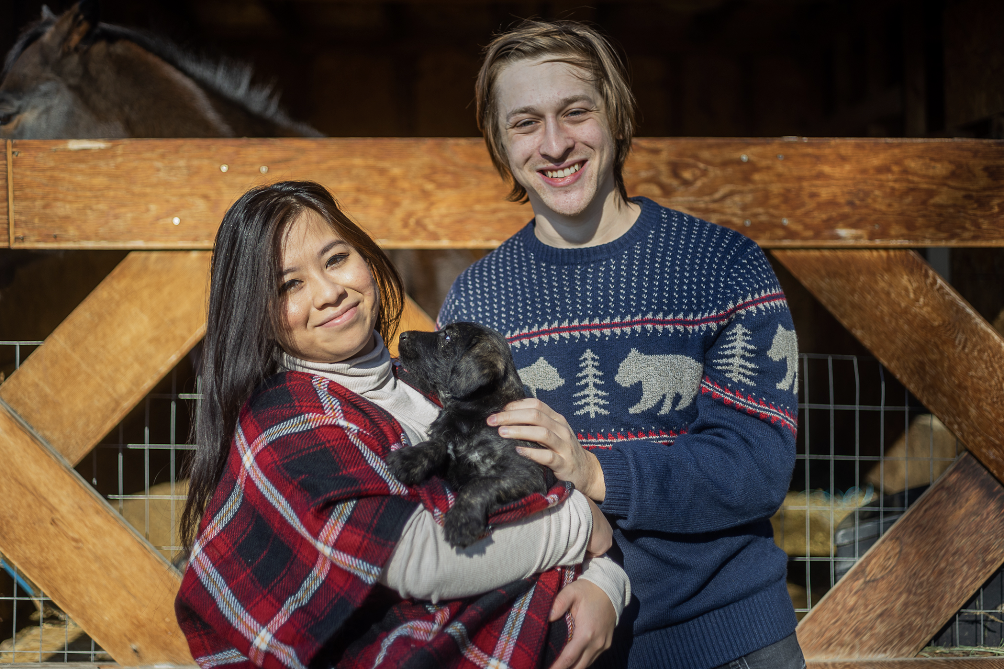 Stephanie and Brandon posing with Nyx when she was a puppy